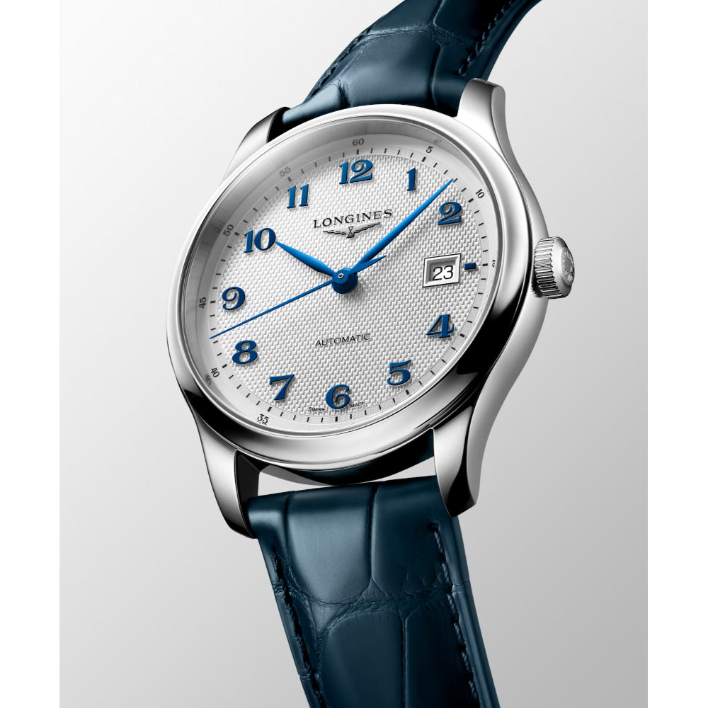A Longines Automatic watch with a silver stainless steel case, a white dial featuring blue Arabic numerals and hands, and a dark blue alligator leather strap, shown against a light gray background.
