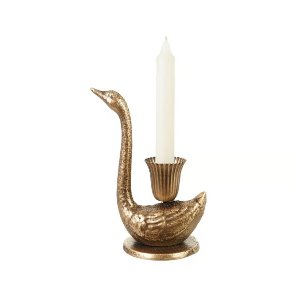 A swan-shaped candle holder in a textured metallic gold finish, holding a single white taper candle, isolated on a white background.