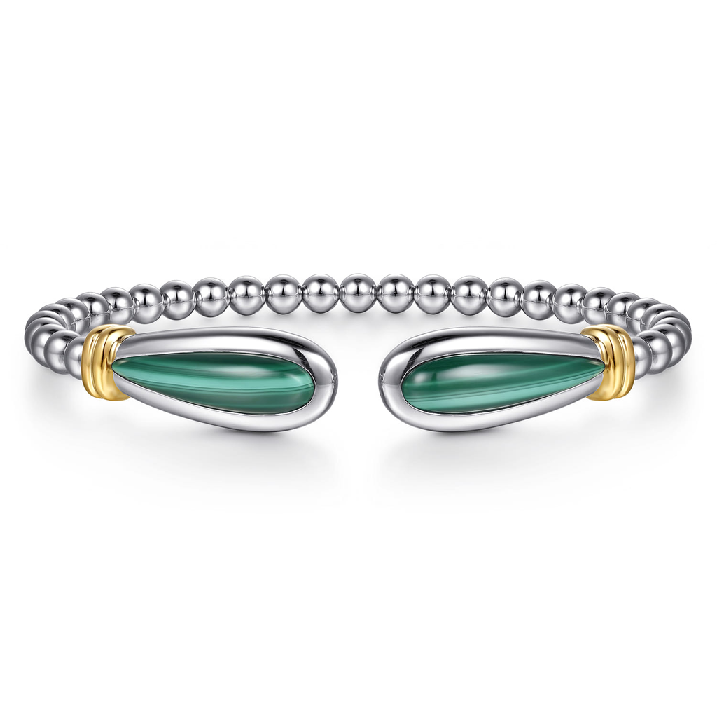 Silver bracelet with green stones and gold accents on a white background