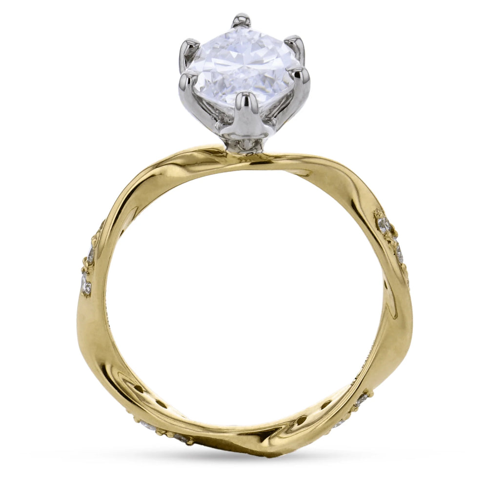 A two-tone diamond ring with a round brilliant-cut clear center stone in a silver-colored prong setting, mounted on a twisted yellow gold band with small accent diamonds, shown on a white background.