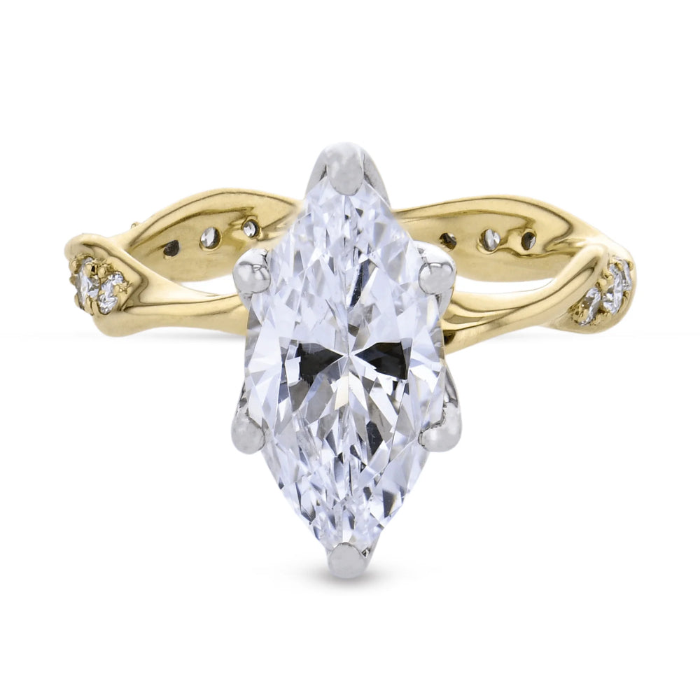 A yellow gold ring featuring a large marquise-cut clear gemstone in a prong setting, with small accent stones along the split shank, shown on a plain white background.