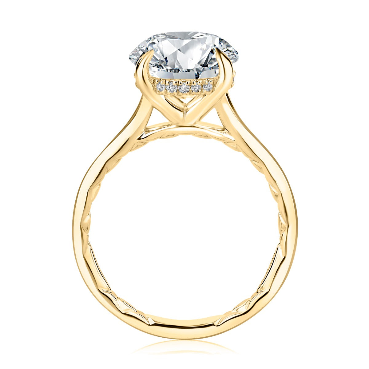 gold ring from the side with clear stone on white background