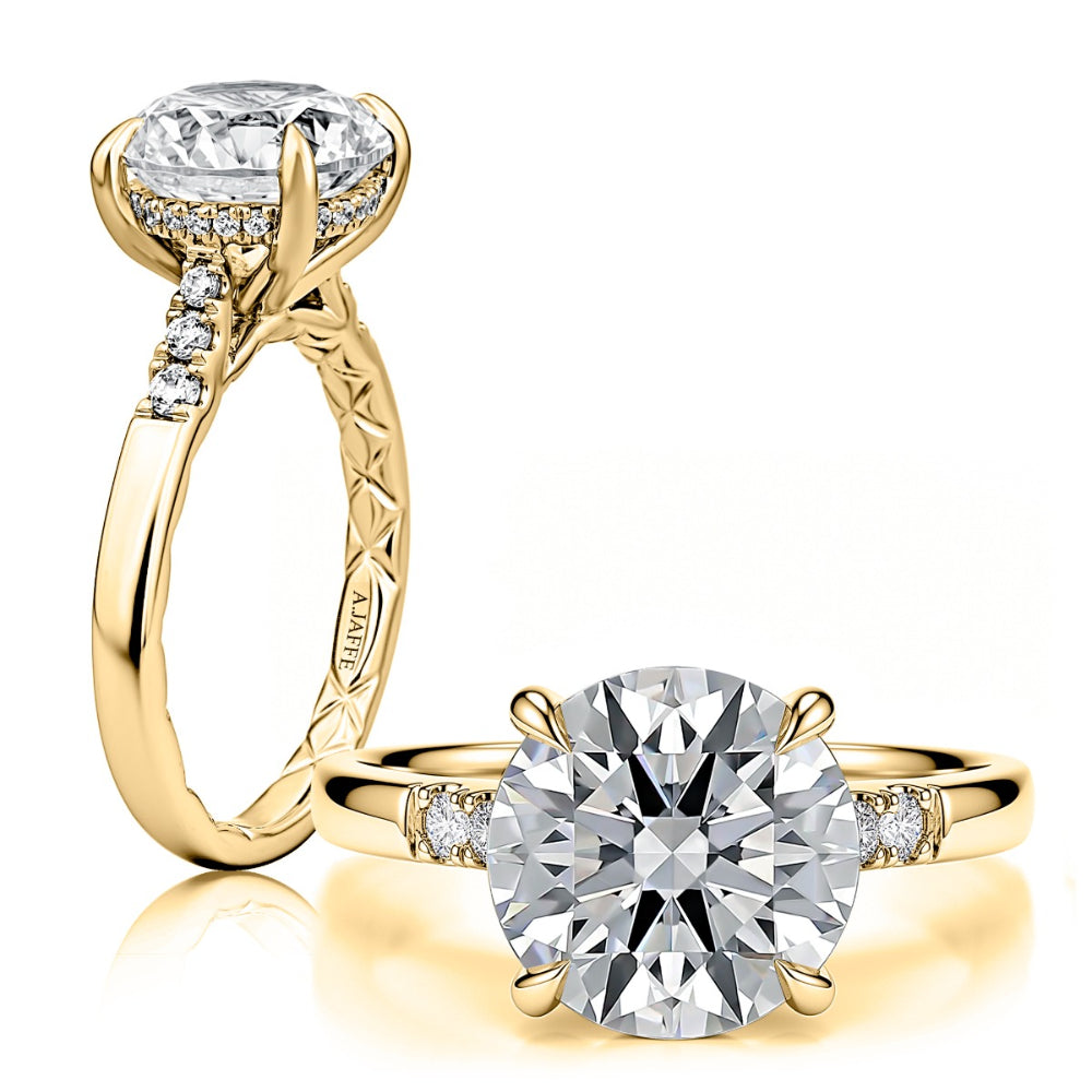 A yellow gold engagement ring with a large round brilliant-cut diamond center stone and smaller diamonds along the band, shown in two angles on a clean white background.
