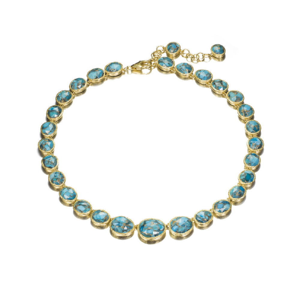 gold necklace with blue/green stones on white background