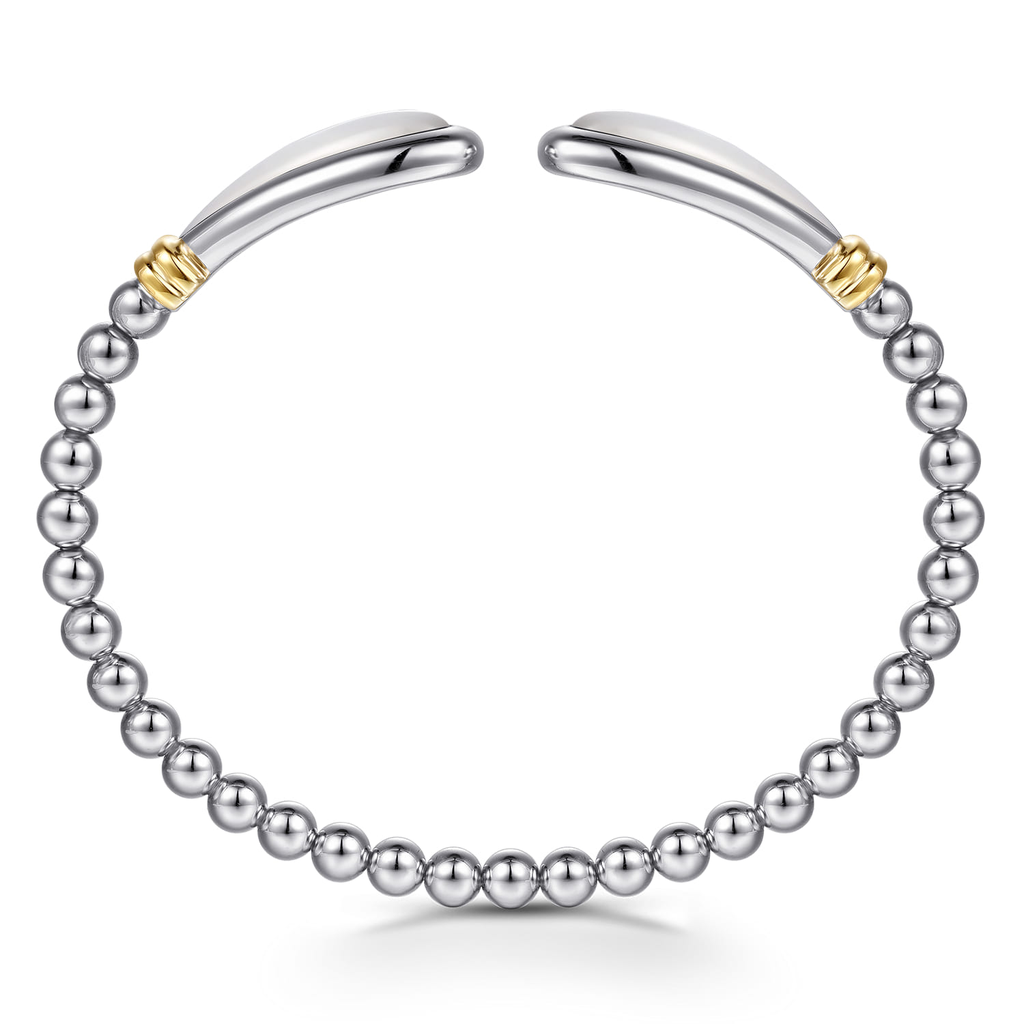 Silver beaded bracelet with gold accents on a white background