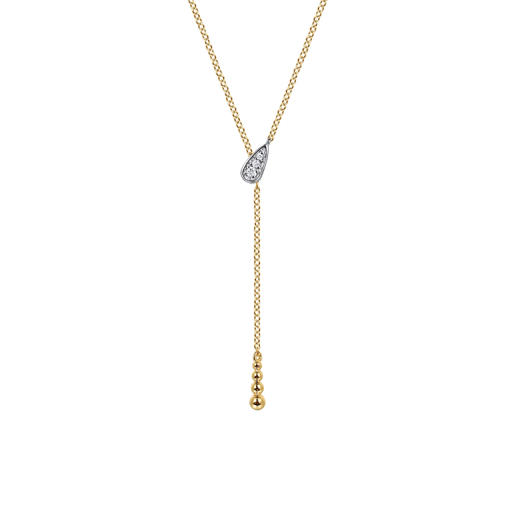 A delicate gold Y-necklace featuring a teardrop-shaped pavé diamond pendant and a dangling chain with three small gold beads at the end, shown on a plain white background.