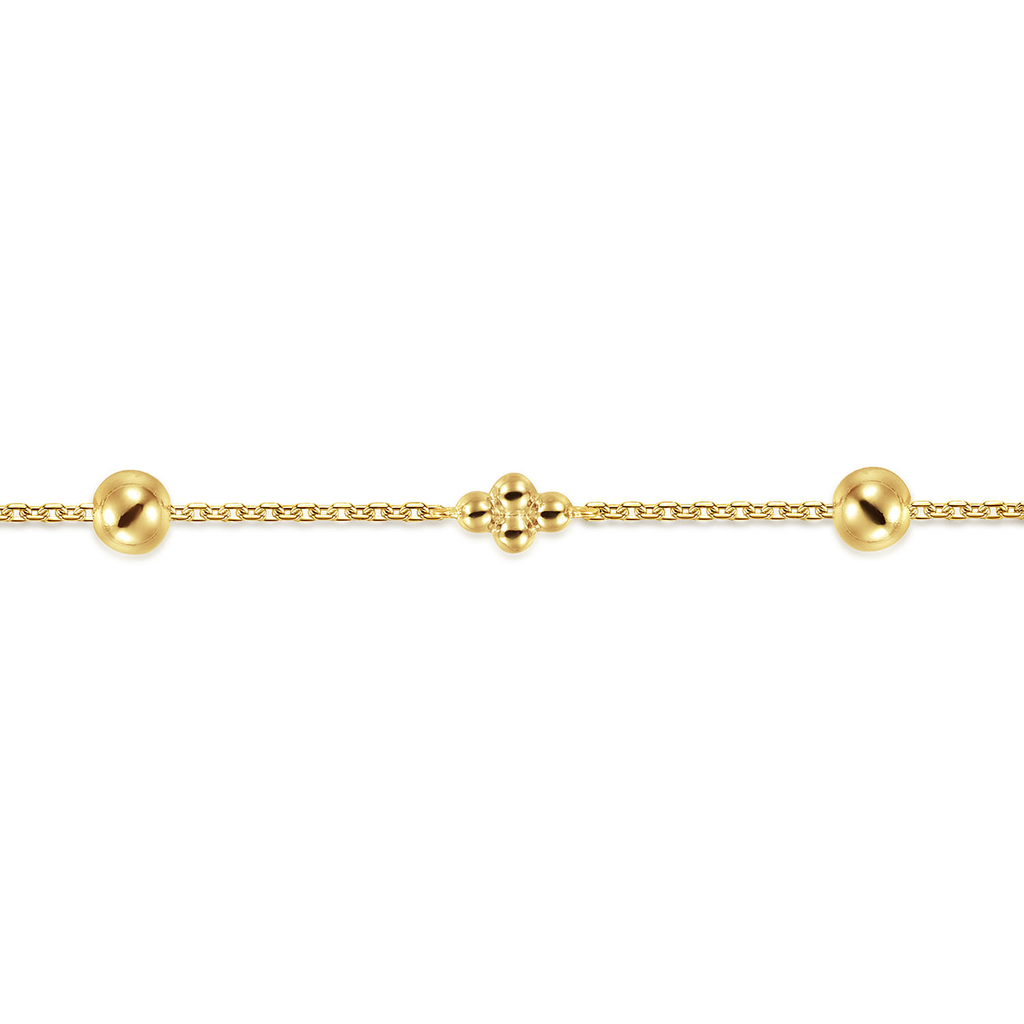 gold beaded clover bracelet on white background