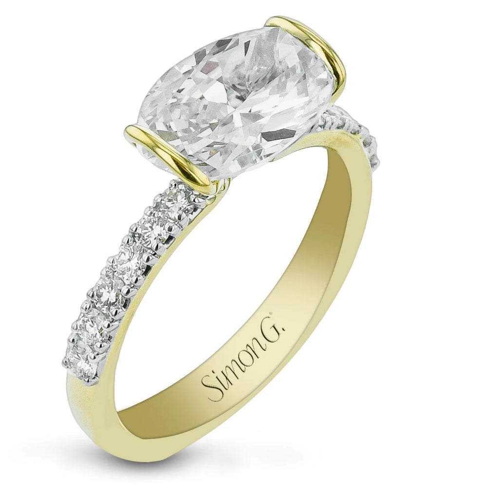A yellow gold diamond engagement ring featuring a large oval-cut center stone and pavé-set diamonds along the band, with 'Simon G.' engraved inside the band, shown on a white background.