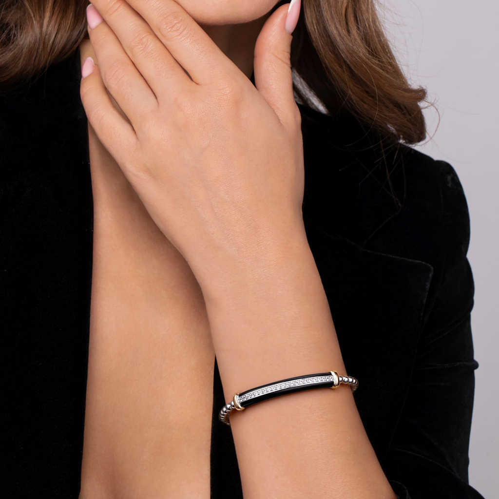 woman wearing silver bracelet on white background