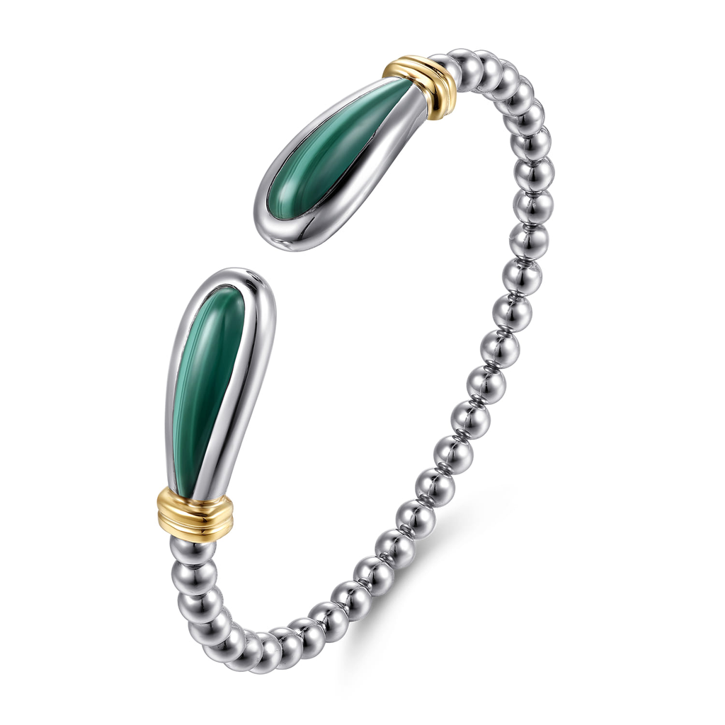 Silver bracelet with green stone accents on a white background