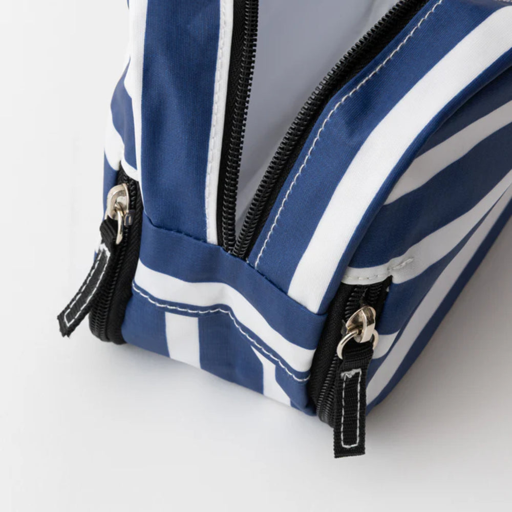 Blue and white striped bag with zippers on a light gray background