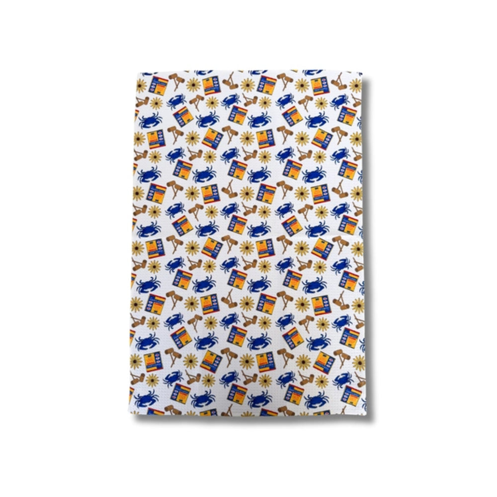 Kitchen towel with a colorful pattern of crabs, flowers, and old bay boxes on a white background