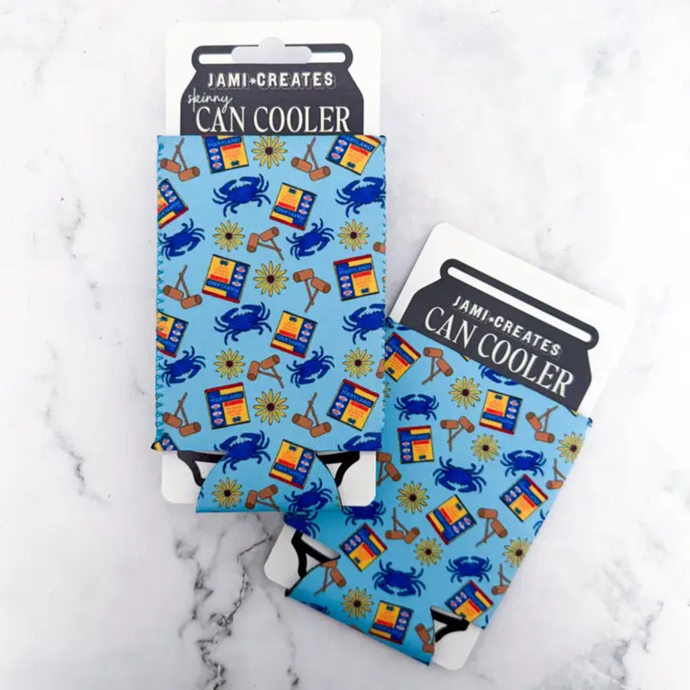 Two can coolers with a colorful design on a marble surface