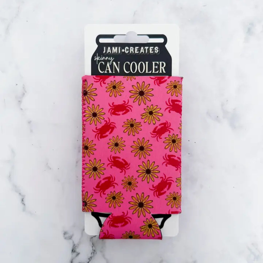 Pink can cooler with crab and flower pattern on a marble background