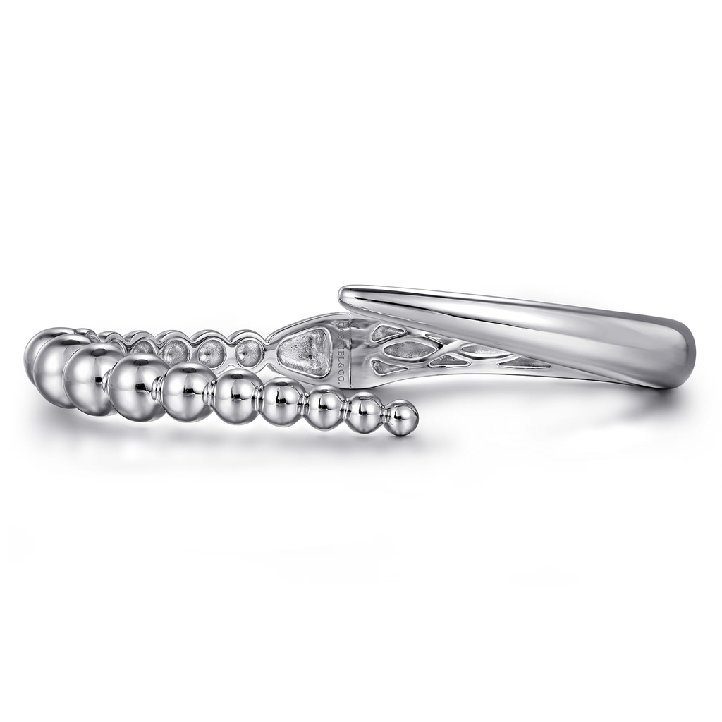 Silver ring with beaded design on a white background