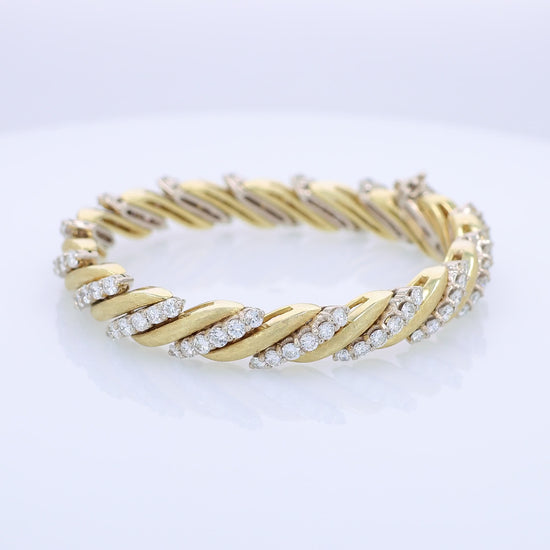 360 degree video of a two-tone gold bracelet with diamond accents on a white background