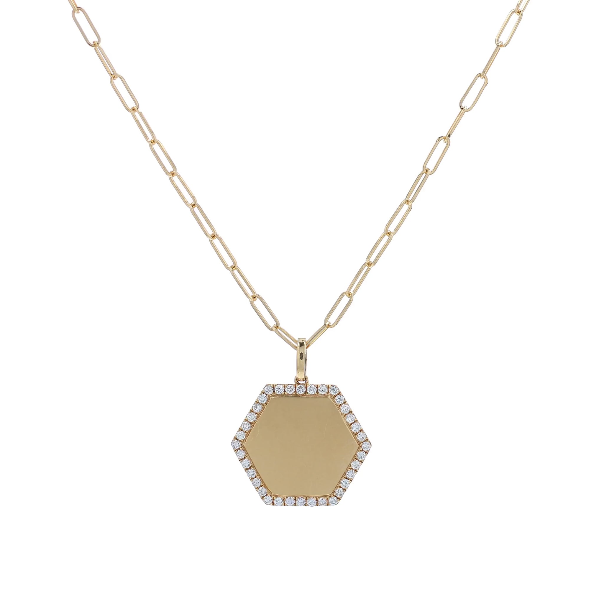 A gold hexagonal pendant necklace with a pavé diamond border and a paperclip chain, shown on a white background