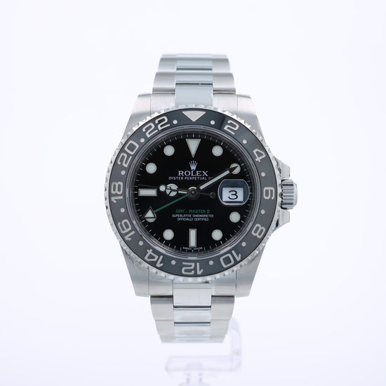 360 degree video of a stainless steel Rolex GMT II watch with a black bezel and dial on a white background