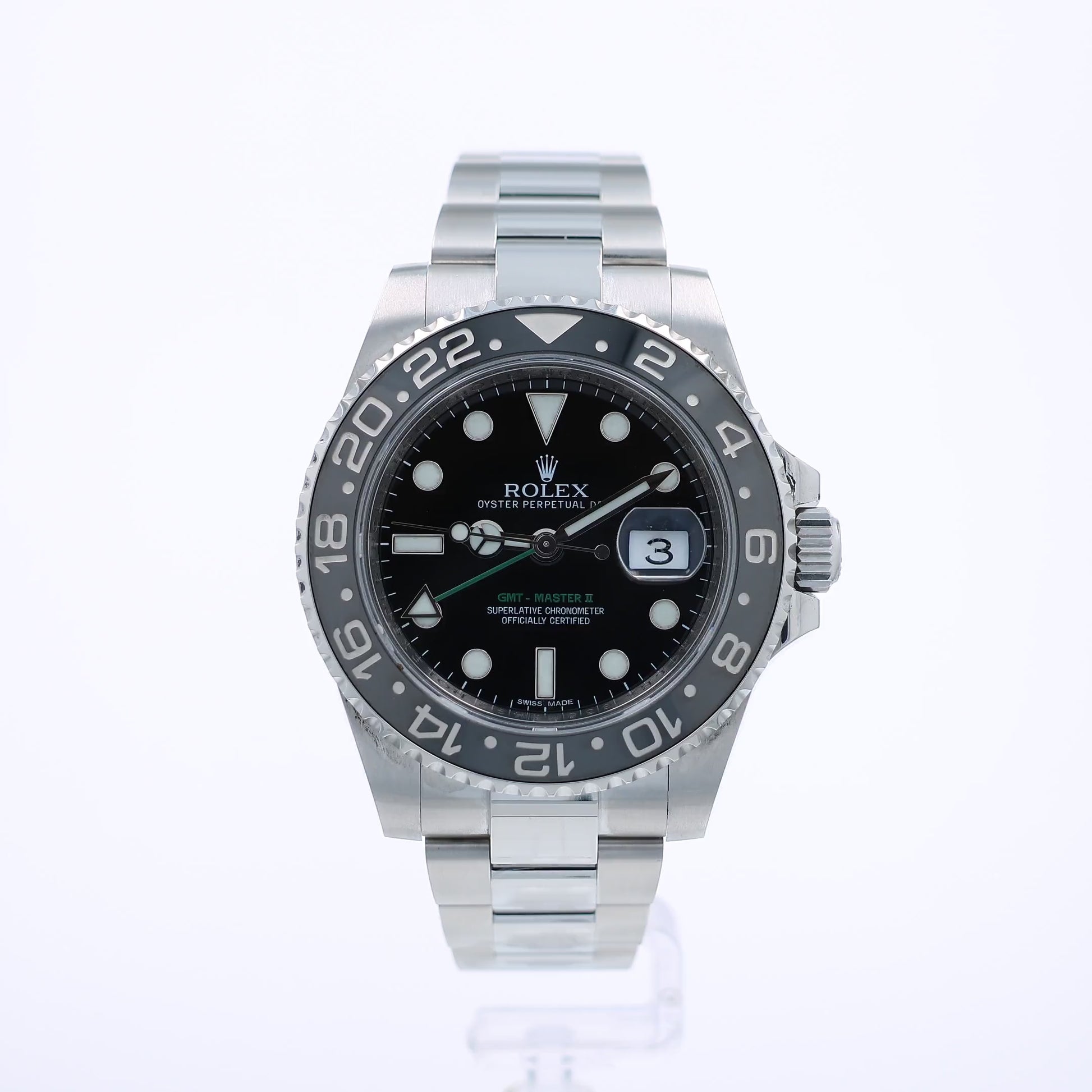 360 degree video of a stainless steel Rolex GMT II watch with a black bezel and dial on a white background