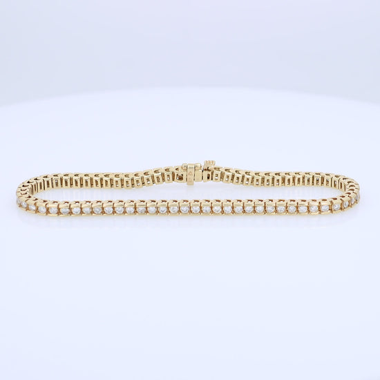 Yellow gold Diamond tennis bracelet totaling 1.63 carats on a white background