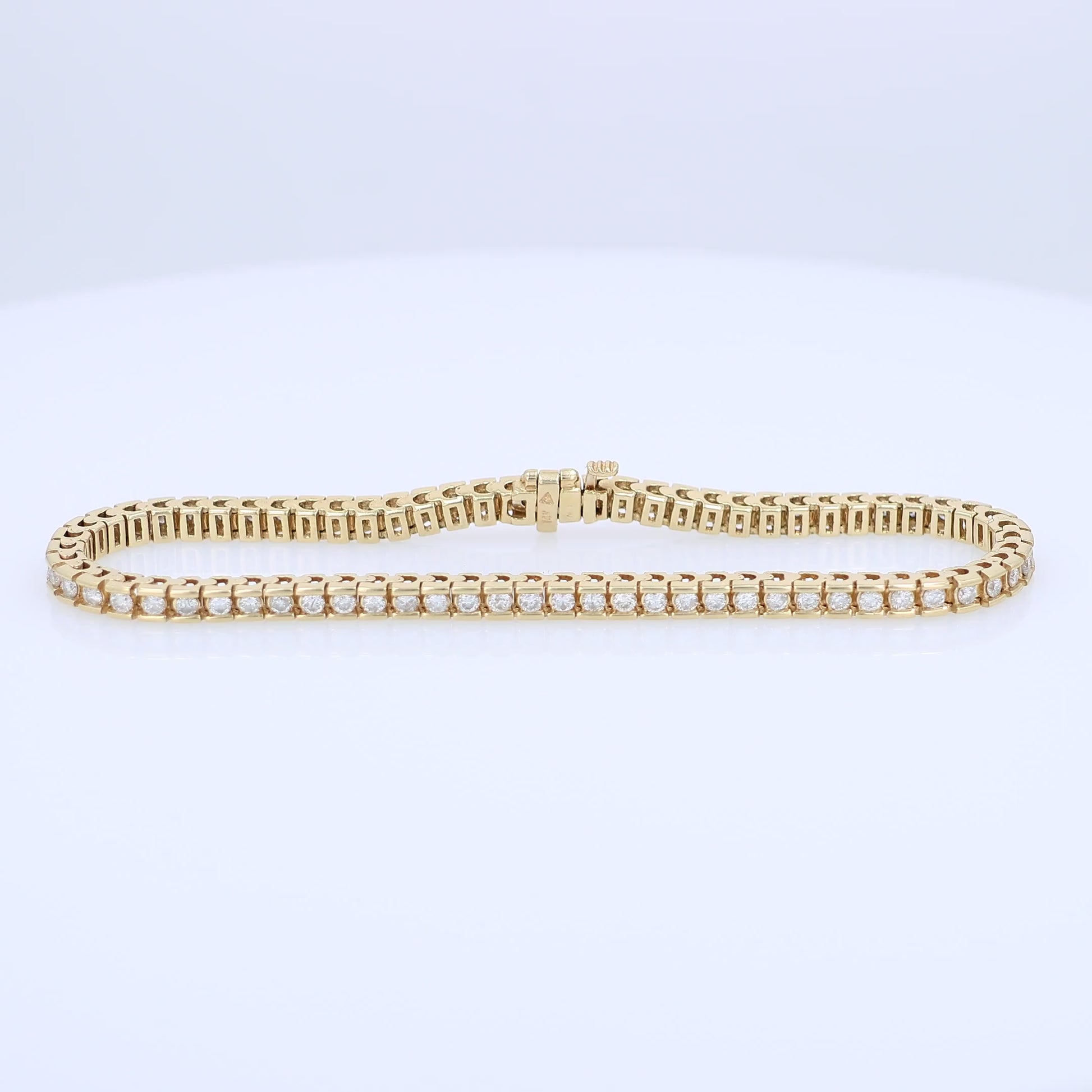 Yellow gold Diamond tennis bracelet totaling 1.63 carats on a white background