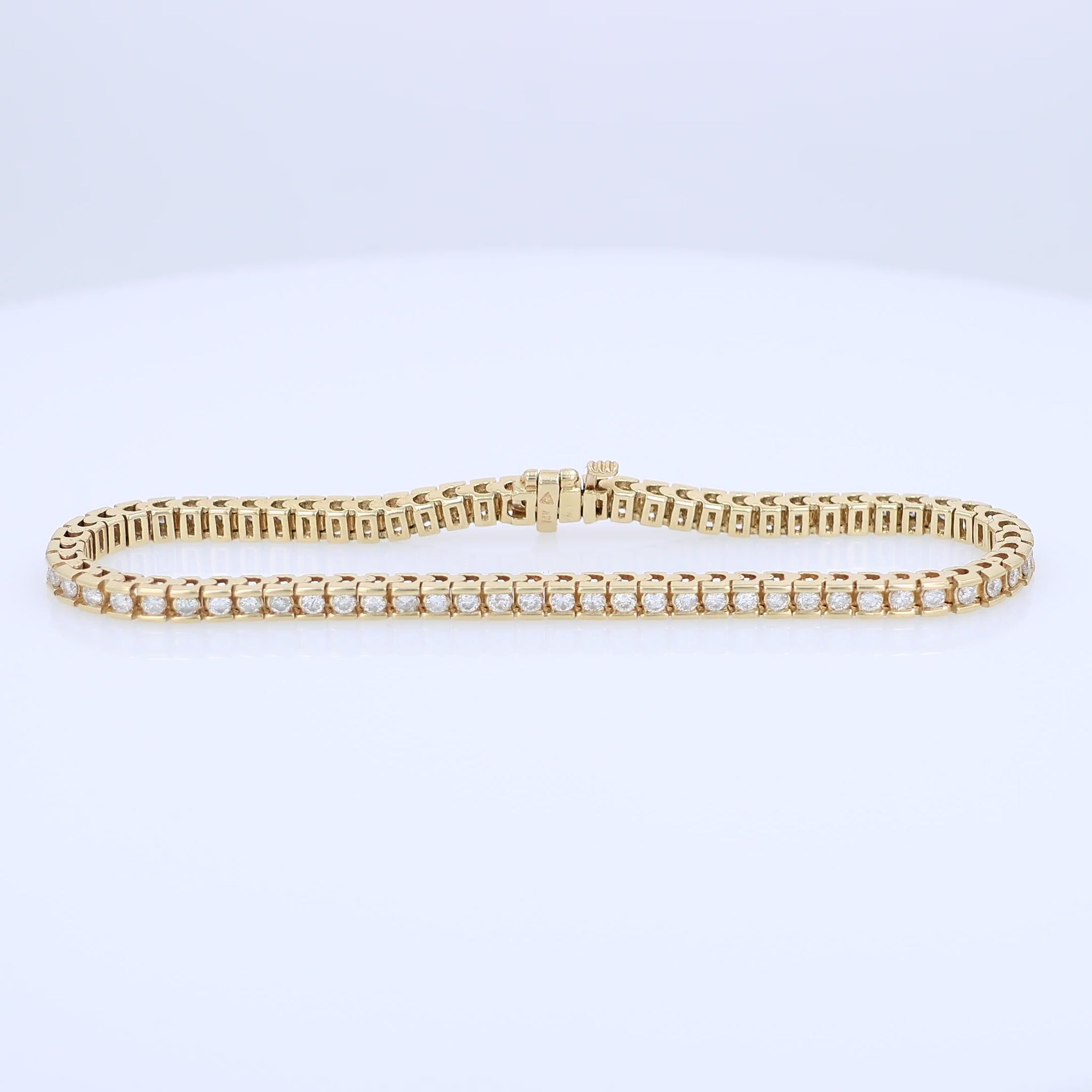 Yellow gold Diamond tennis bracelet totaling 1.63 carats on a white background