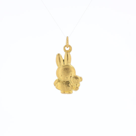 Yellow gold pendant depicting Miffy the Rabbit holding a stuffed animal bear on a white background