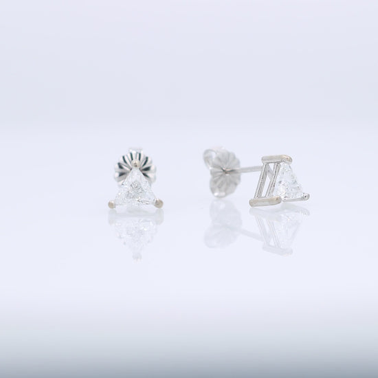 White gold trillion cut diamond stud earrings totaling 0.76 carats on a white background
