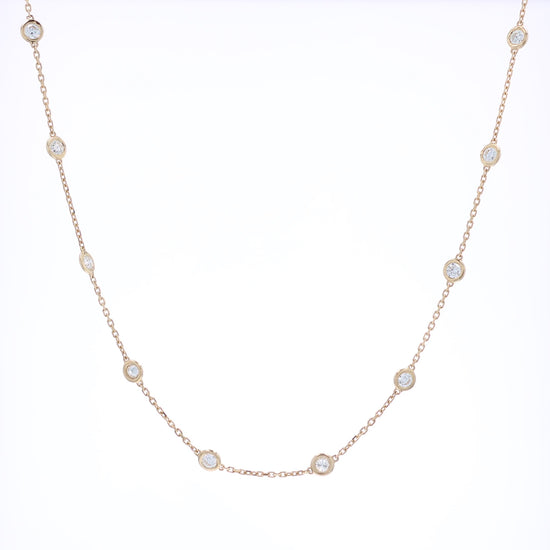Yellow gold Diamonds By The Yard diamond station necklace on a white background