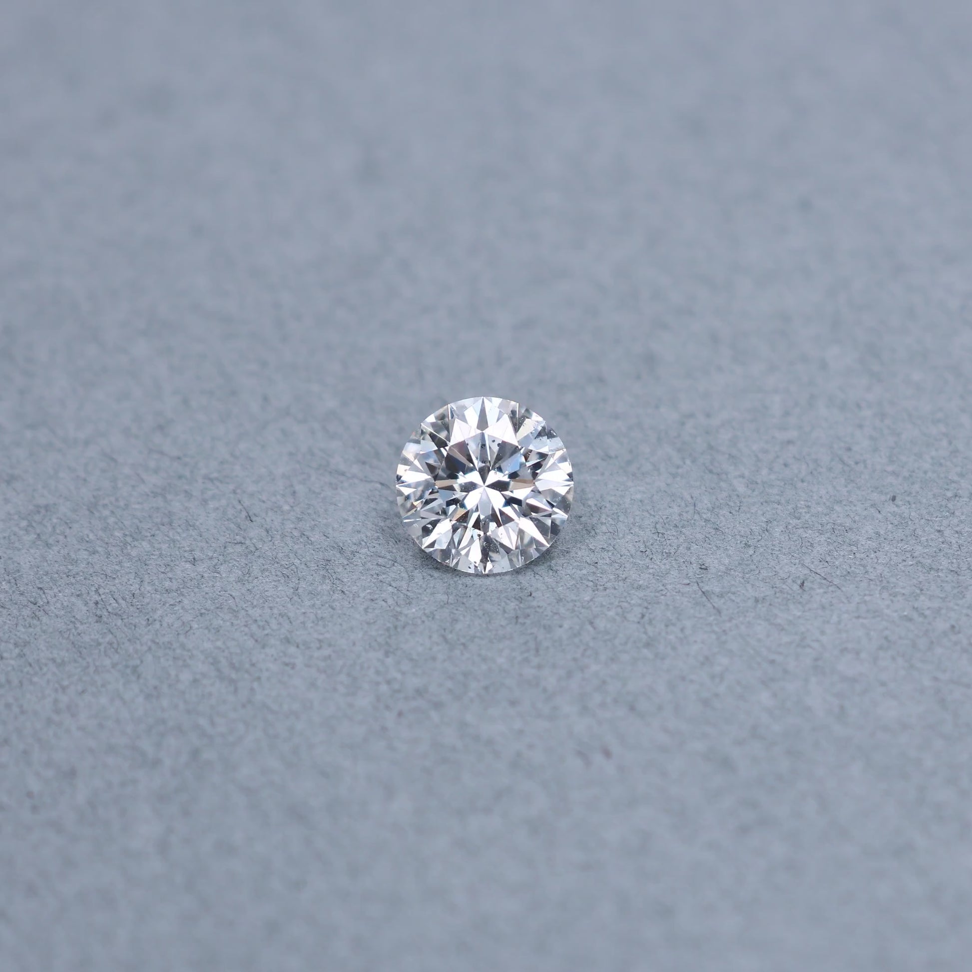 Round 2.00 carat GIA certified diamond graded DSI2 on a grey background