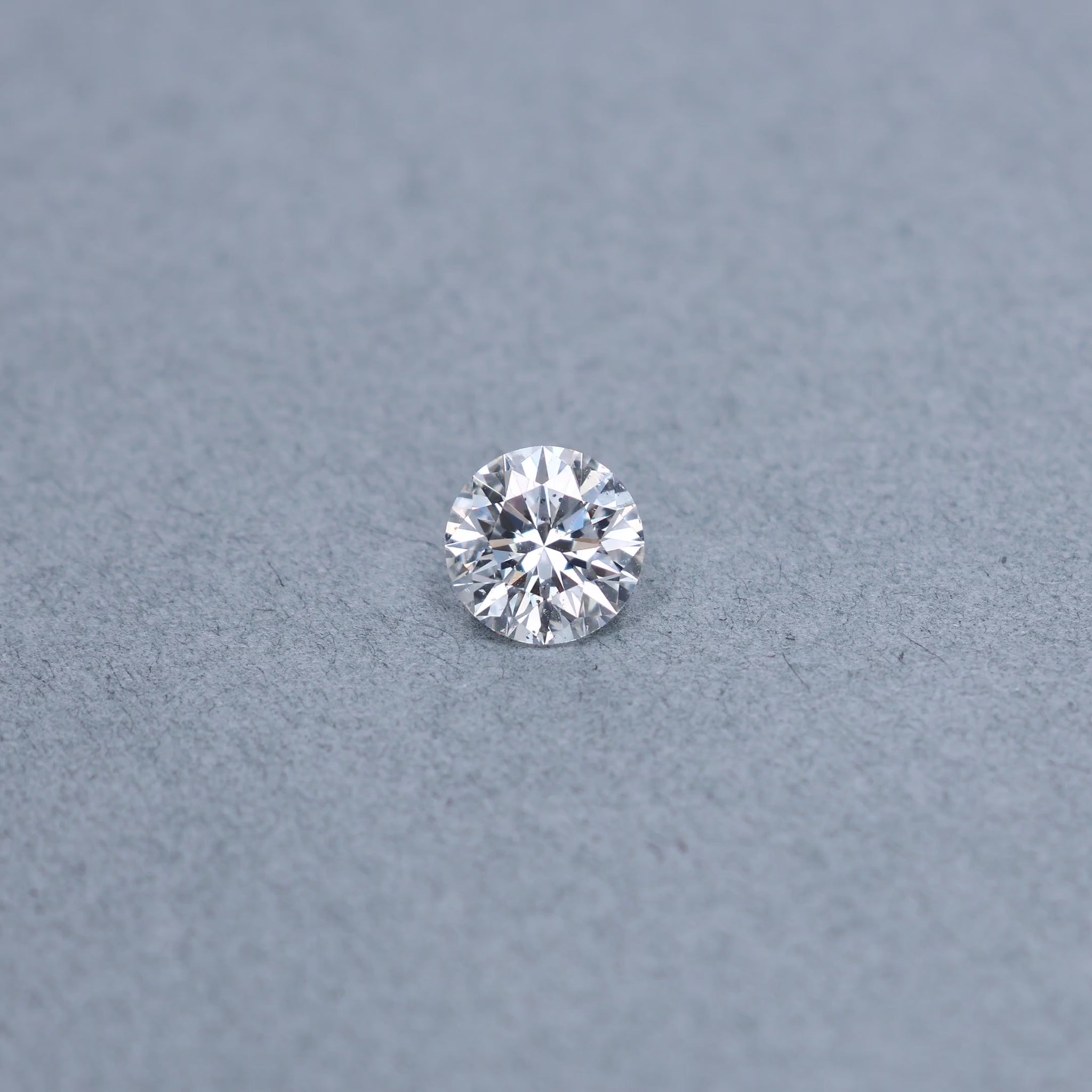 Round 2.00 carat GIA certified diamond graded DSI2 on a grey background