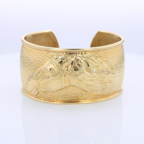 360 degree video of a gold cuff bracelet with horse head design on a white background
