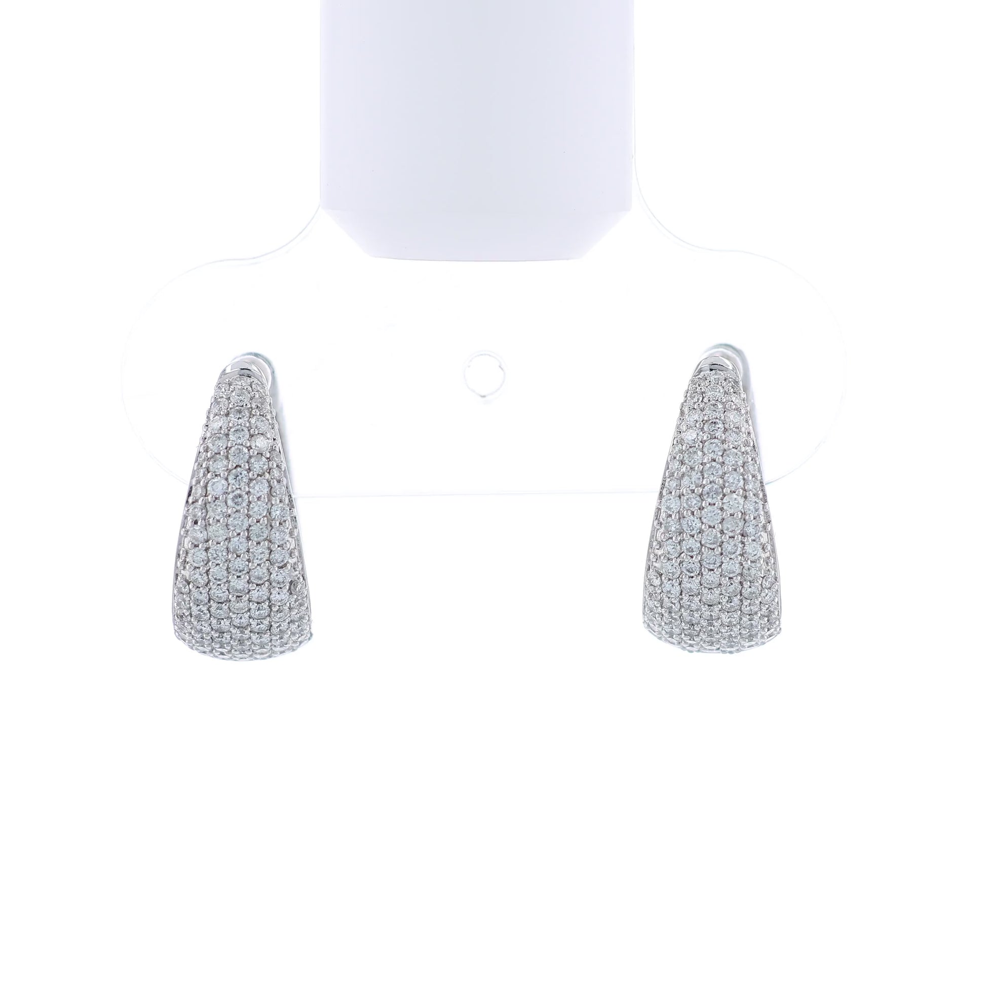 Pair of white gold diamond pave hoop earrings on a white background