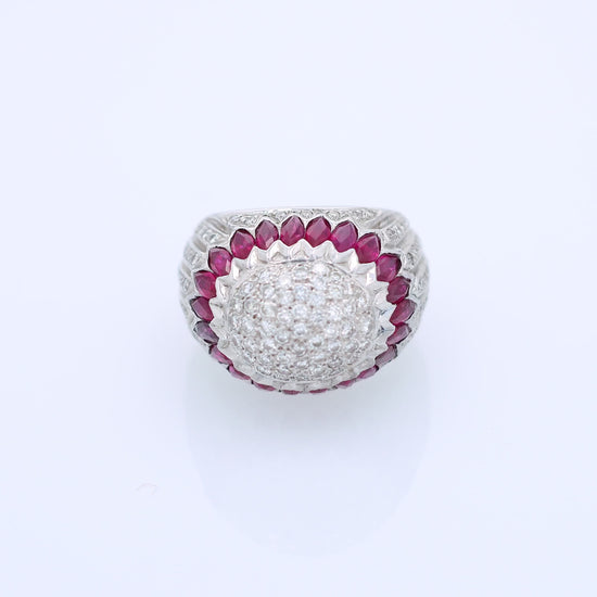 Elegant white gold ring with marquise rubies and diamond accents on a white background