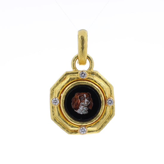 A gold pendant charm featuring a textured octagonal frame with four diamonds and a central black round inset displaying a mosaic portrait of a brown and white spaniel dog.
