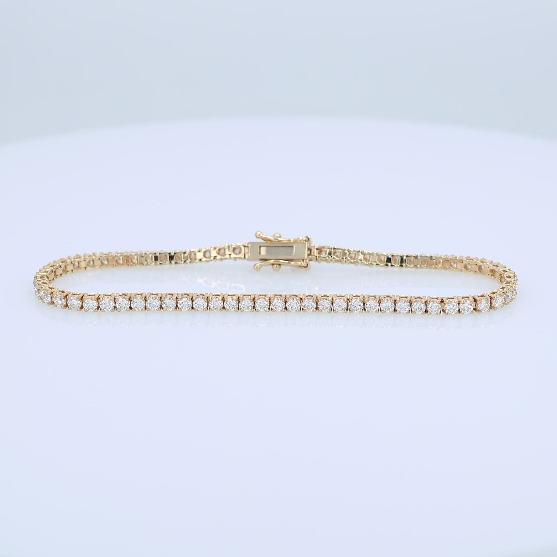 Yellow gold 3.40 carat diamond tennis bracelet on a white background