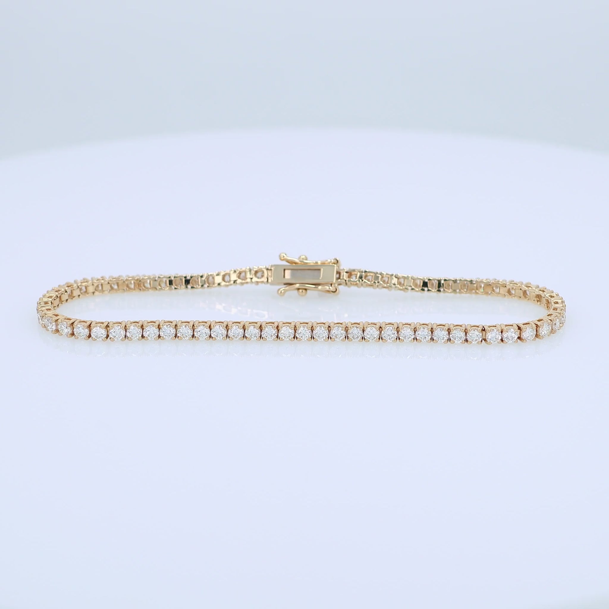 Yellow gold 3.40 carat diamond tennis bracelet on a white background