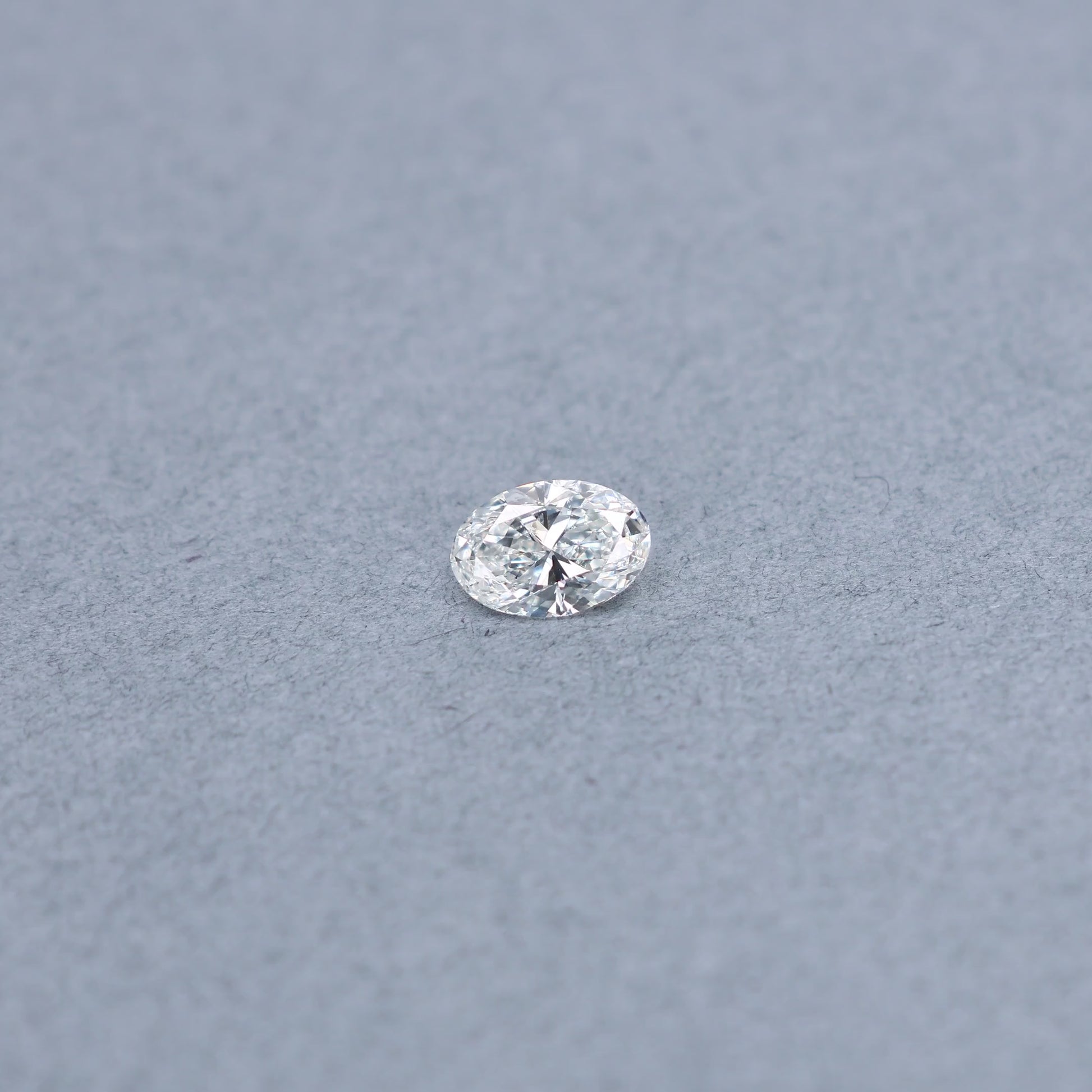 Oval 1.01 carat GIA certified diamond graded GSI2 on a grey background