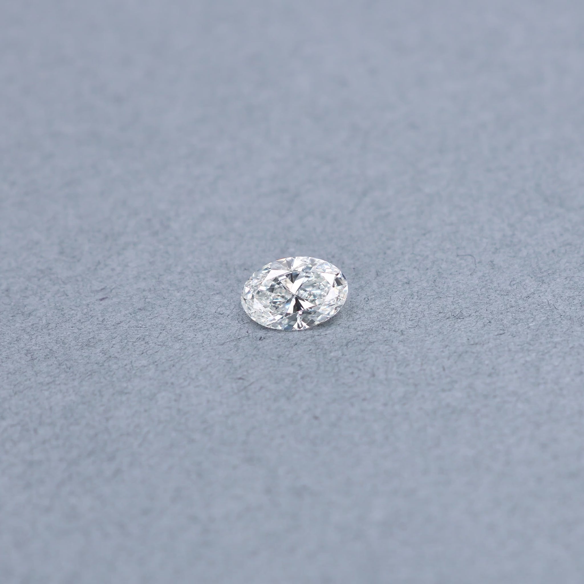 Oval 1.01 carat GIA certified diamond graded GSI2 on a grey background