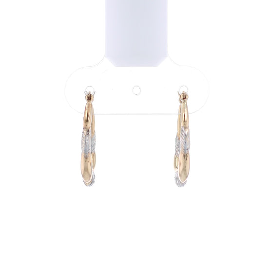 Two-tone gold and silver hoop earrings on a white background