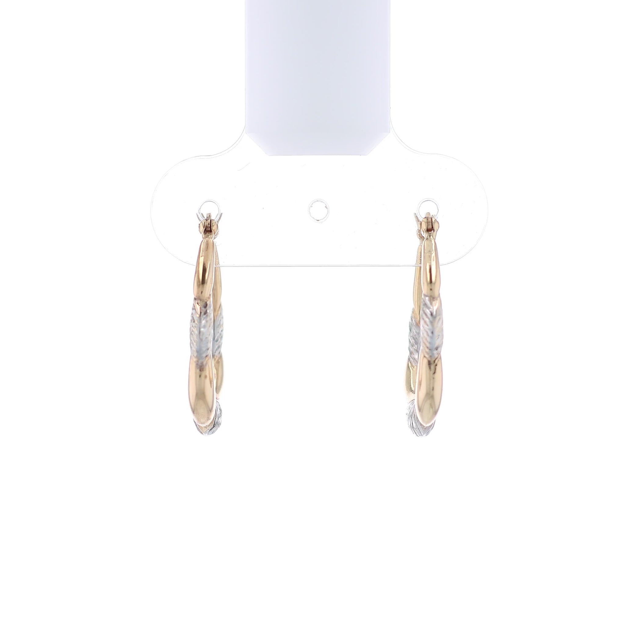 Two-tone gold and silver hoop earrings on a white background