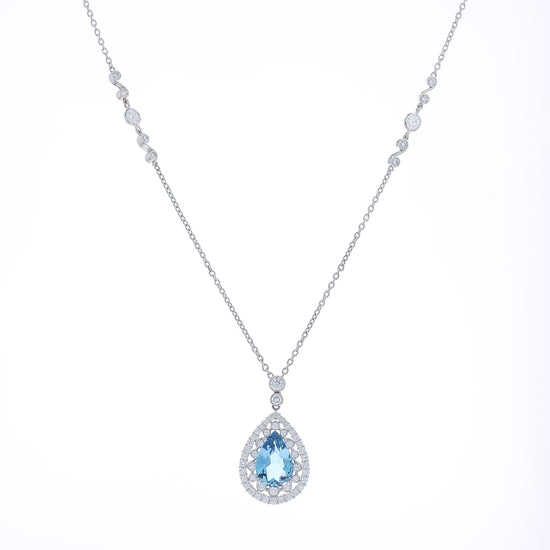 Platinum pear shaped aquamarine and diamond double halo pendant necklace with chain on a white background