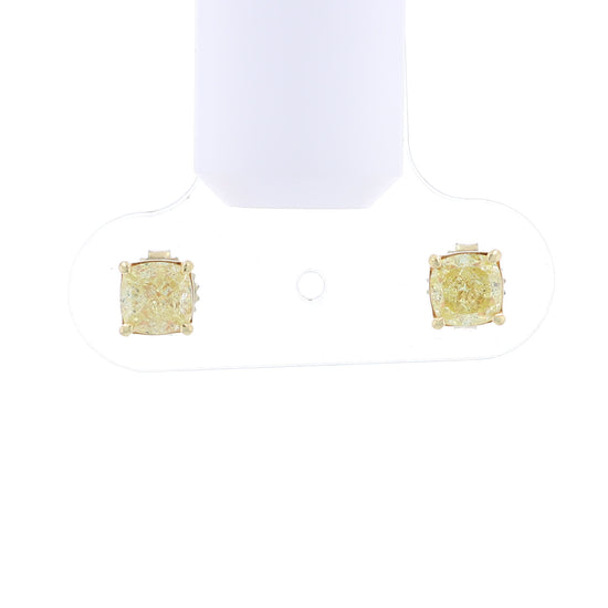 Video of a pair of yellow gold stud earrings with cushion-cut fancy yellow diamonds on a white background