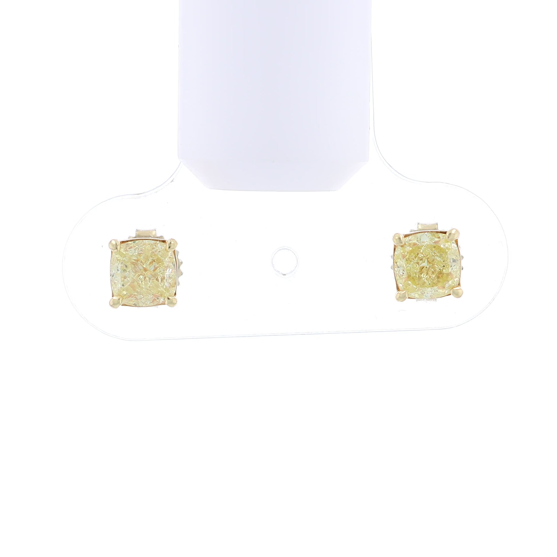 Video of a pair of yellow gold stud earrings with cushion-cut fancy yellow diamonds on a white background