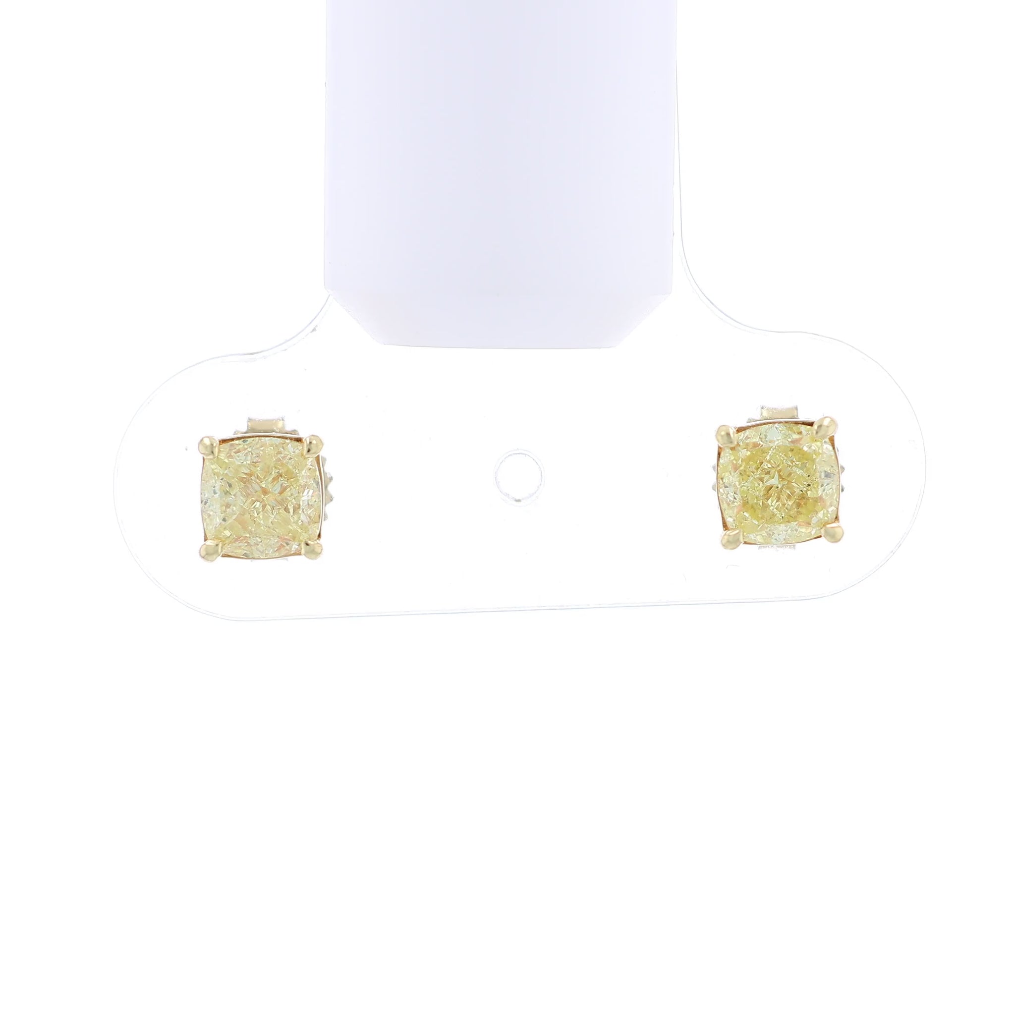 Video of a pair of yellow gold stud earrings with cushion-cut fancy yellow diamonds on a white background