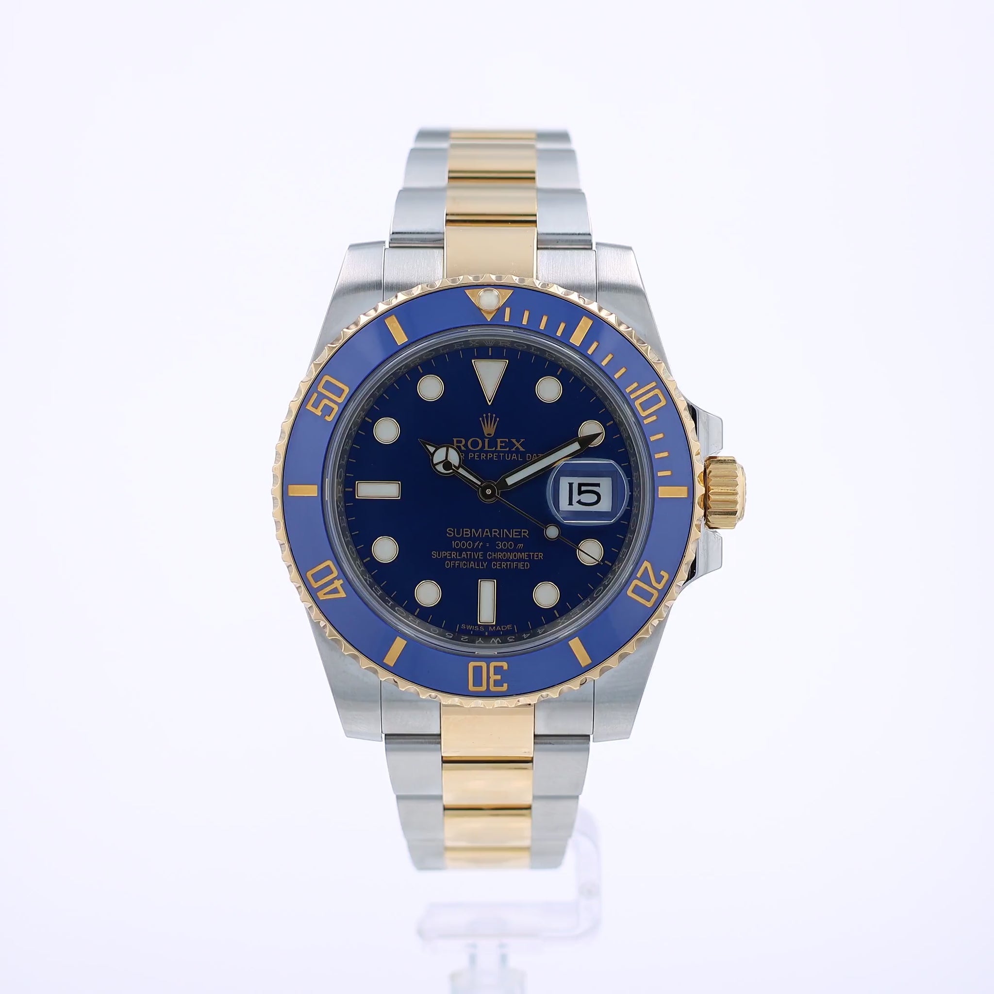 360 degree video of a steel and gold Rolex Submariner watch with a blue bezel and dial on a white background