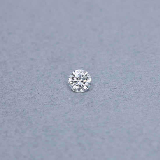 Round 1.01 carat diamond graded KI1 on a grey background