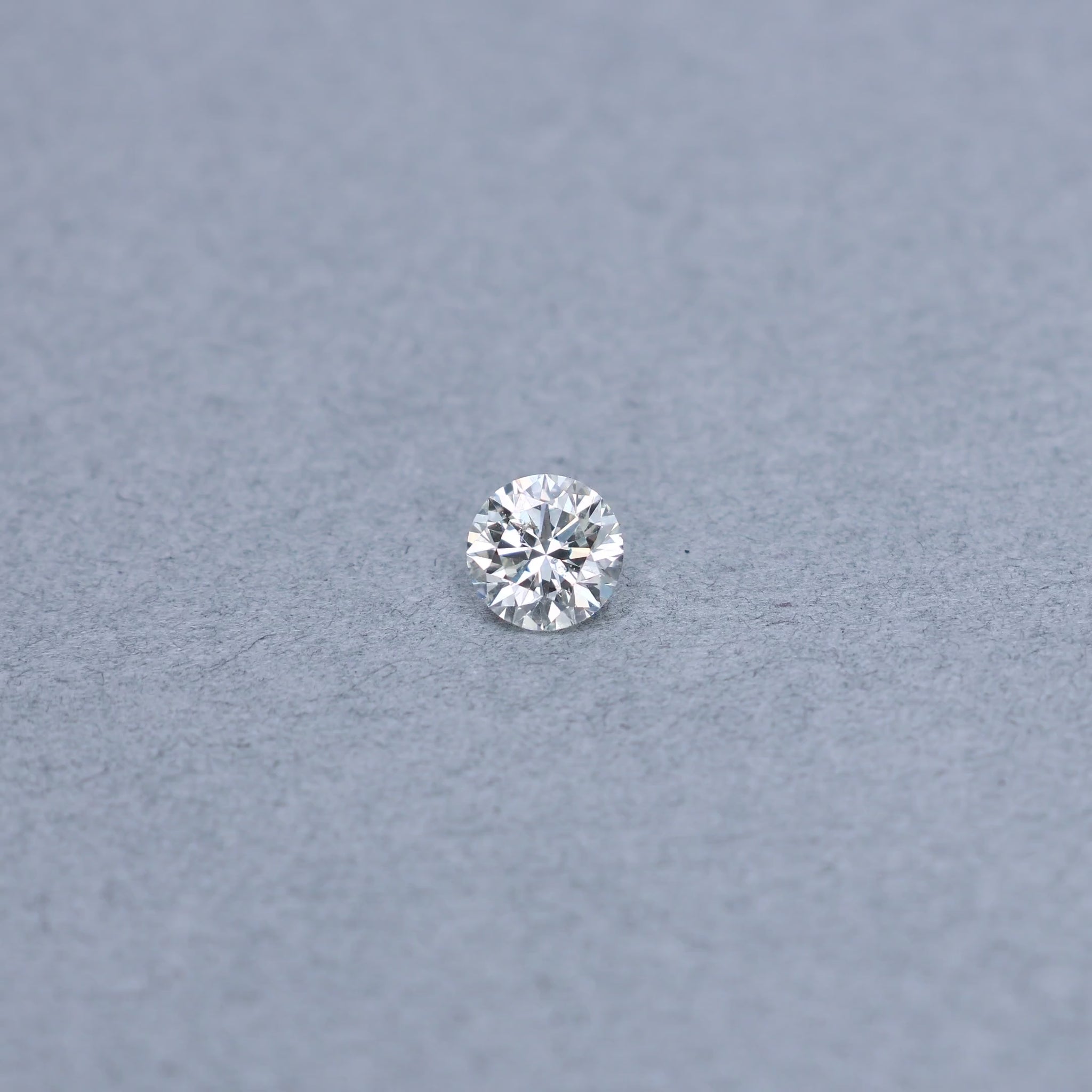 Round 1.01 carat diamond graded KI1 on a grey background