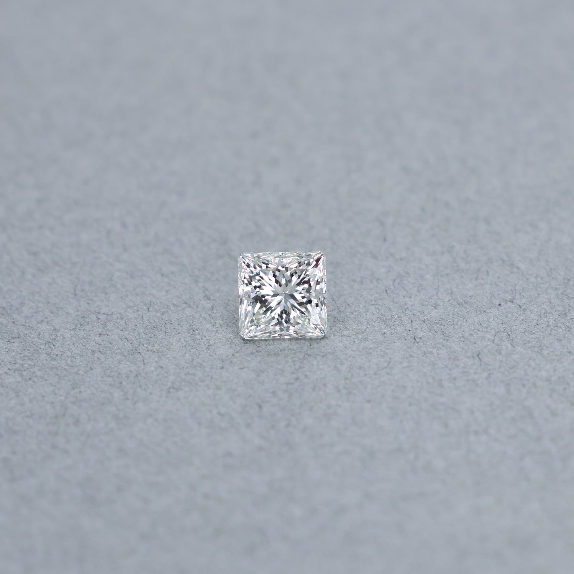 Princess 1.71 carat GCAL certified diamond graded JVS2 on a grey background