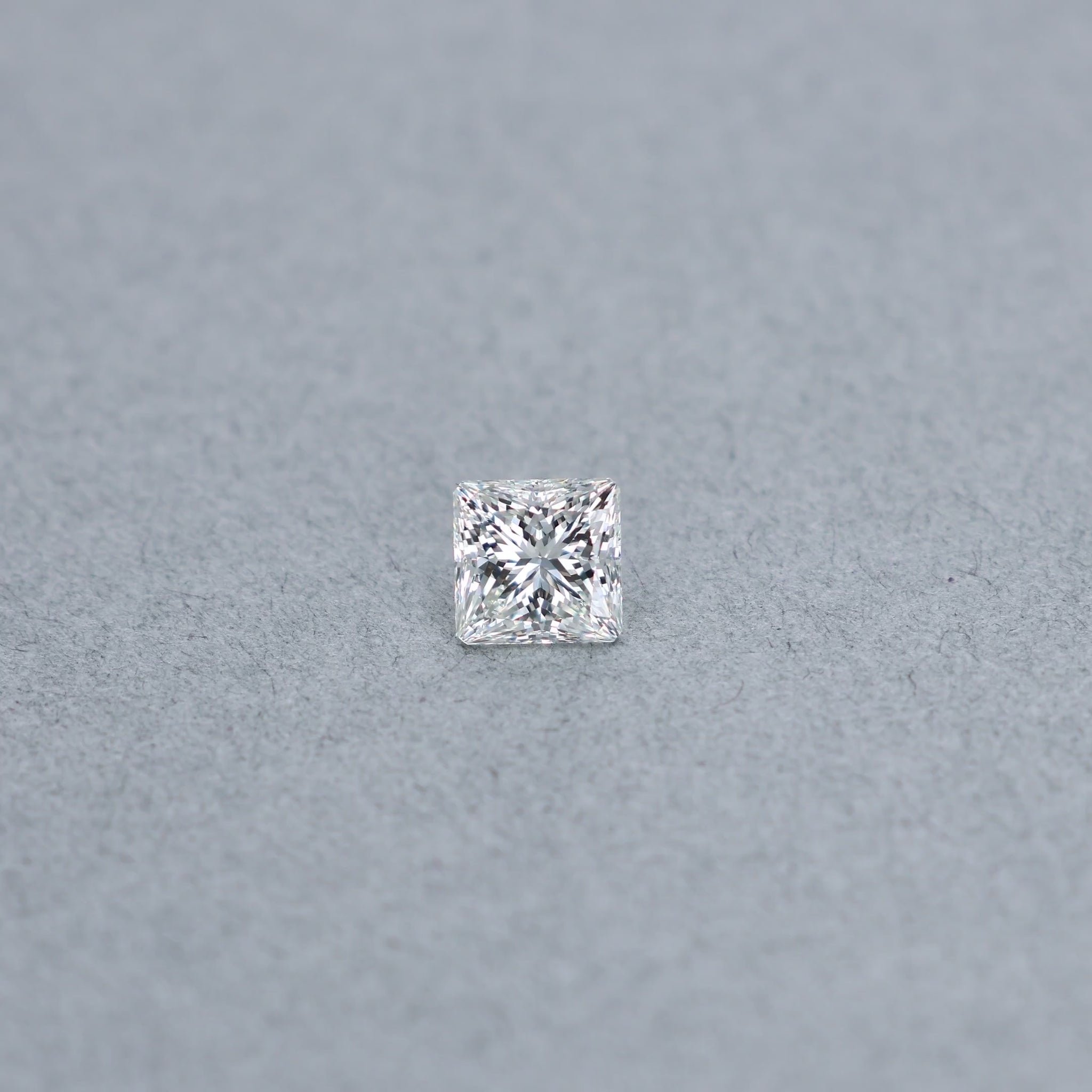 Princess 1.71 carat GCAL certified diamond graded JVS2 on a grey background